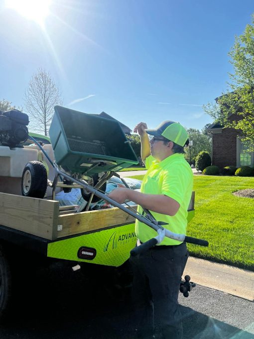 A team member unloading stuff from Advanced Turf Care for lawn care